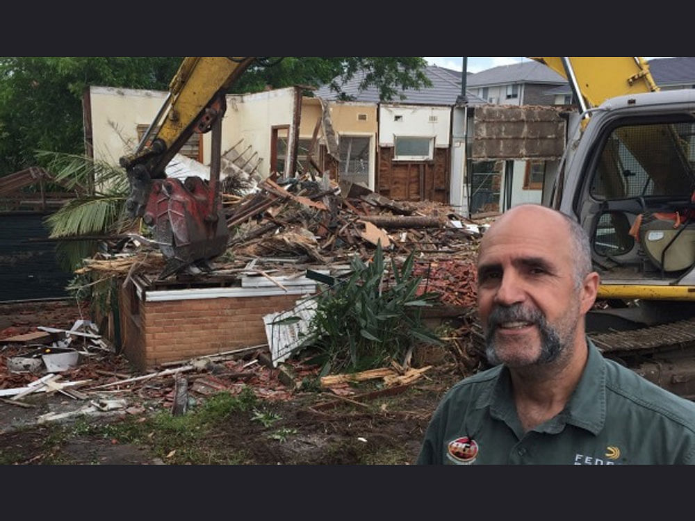 Steve Ballas, a businessman from Sydney suburb, could not believe it when a friend rang to tell him an excavator was tearing into his three-bedroom  property. screengrab