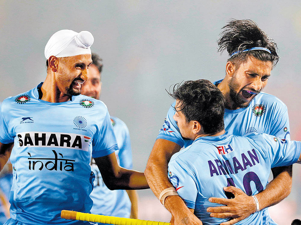 Jubilant: India's Armaan Qureshi celebrates with team-mates after scoring against England on Saturday.