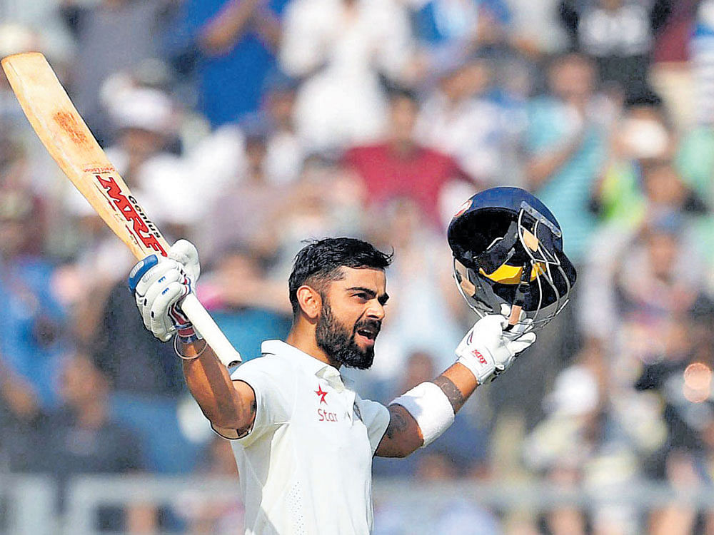 super knock: Virat Kohli celebrates after reaching his century on the third day of the fourth Test against England in Mumbai. PTI