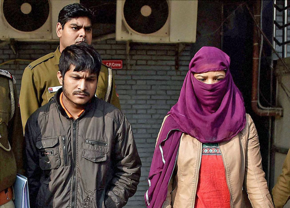 Two accused arrested by the Delhi Police in the Munirka twin blind murders case being produced before the court in New Delhi on Saturday. PTI Photo