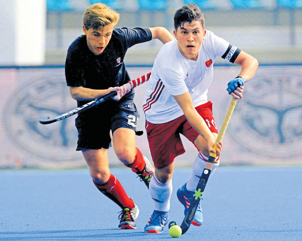 Keen tussle: England's James Gall (right) and Rowan Childs of Canada vie for the ball during a Pool 'D' encounter.