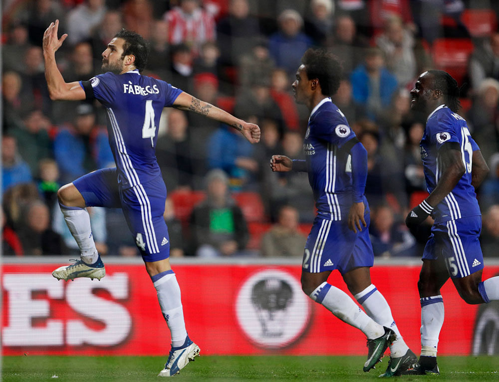 Chelsea's Cesc Fabregas celebrates scoring their first goal with Victor Moses and Pedro. Reuters image