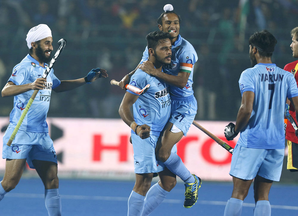 Man of the moment: India's Harmanpreet Singh (second from left) celebrates after scoring the winner against Spain during their quarterfinal match on Thursday. PTI Photo