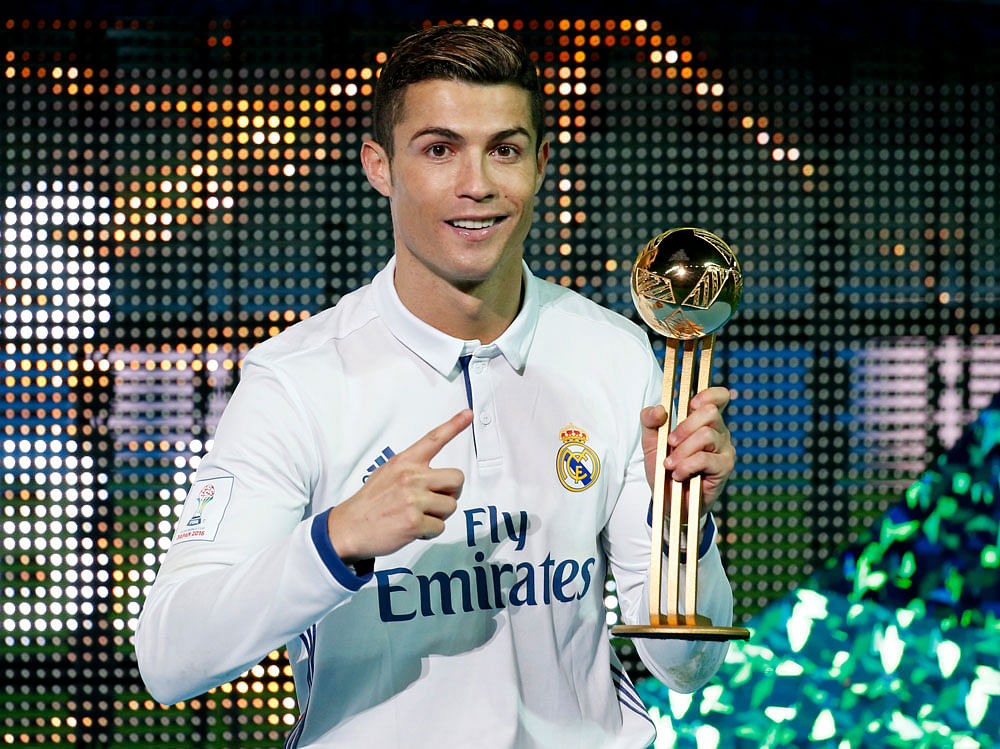 Real Madrid's Cristiano Ronaldo celebrates with the Golden Ball trophy. Reuters Photo