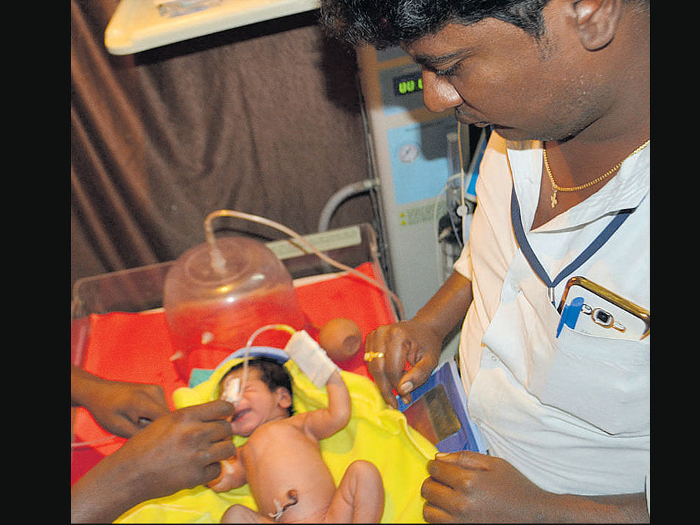 The newborn, which was rescued after it was found wrapped in a piece of burning gunny bag and is being treated at the district hospital in Yadgir on Wednesday. dh photo