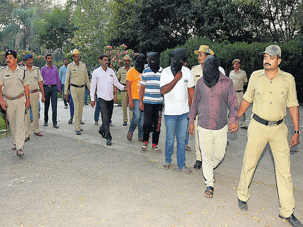 The seven accused, who were arrested in connection with the murder of history-sheeter E Krishna, are being taken to the Police Commissioner's office in Mysuru on Sunday. DH photo