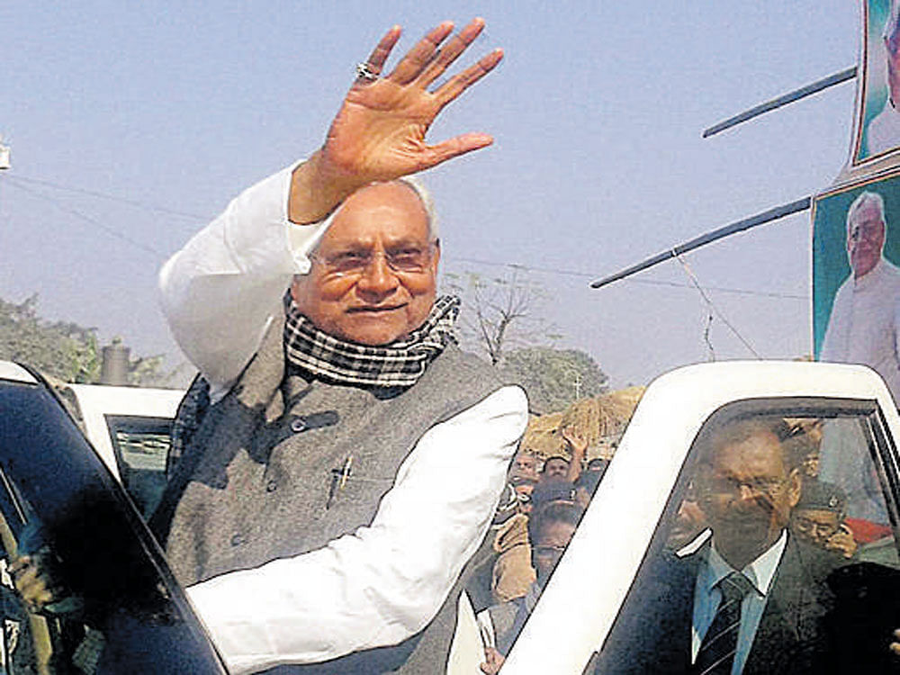 Bihar Chief Minister Nitish Kumar waves at supporters during 'Nischya Yatra' in the Saharsa district of Bihar. PTI