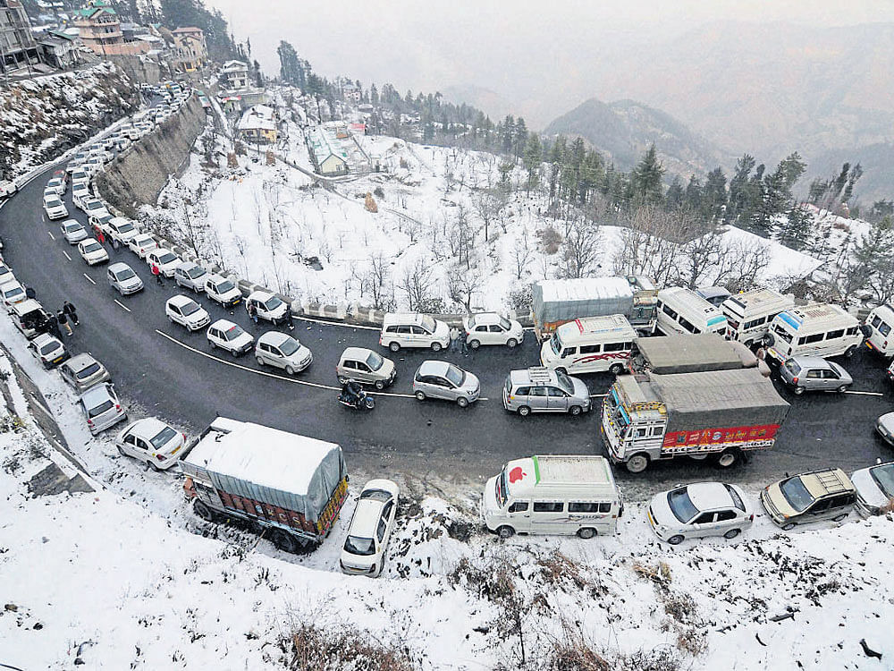 Tourists enjoy a 'White Christmas' in Shimla on Sunday. PTI
