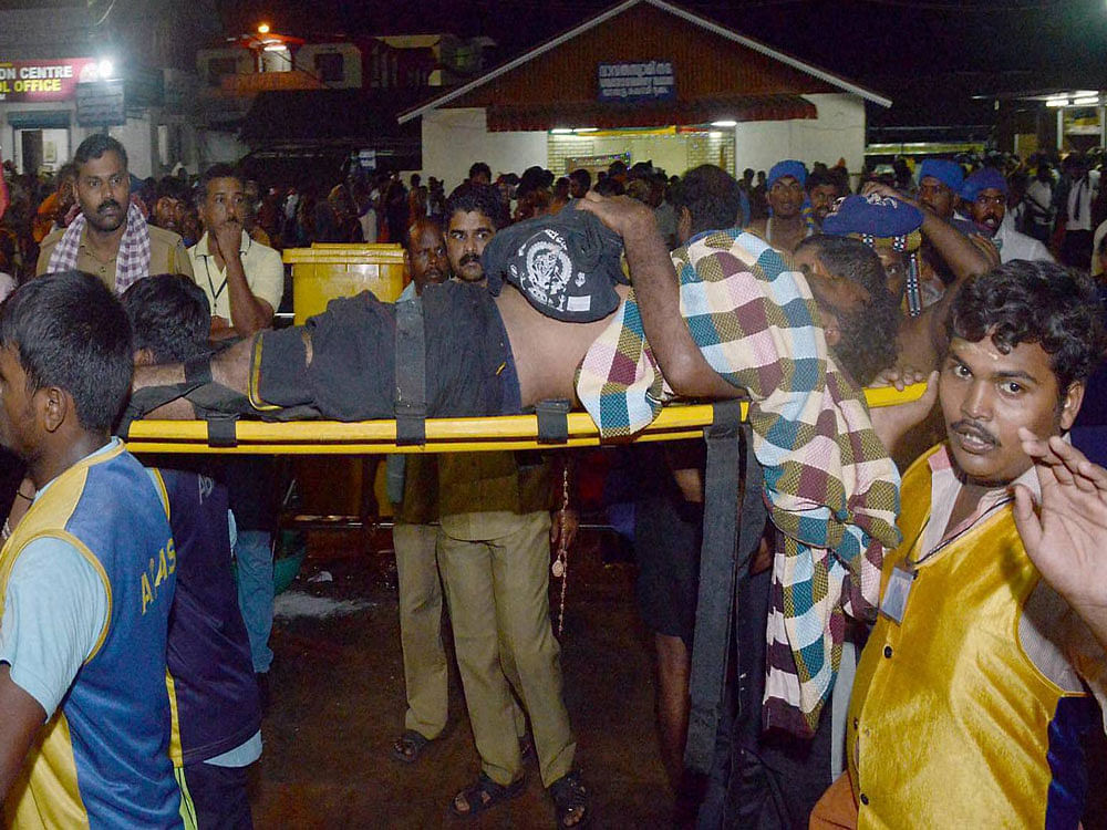 An injured devotee being taken to the hospital in Pamba, after at least 25 persons were injured following a stampede in Sabarimala temple in Kerala on Sunday. PTI Photo