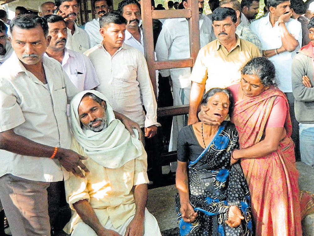 Family members of slain JD(S) workers grieve in front of taluk hospital in Maddur on Monday. Nandeesh and Muthuraju, the JD(S) workers were murdered by their political rivals during the GP election related clash at Thopanahalli in Maddur taluk on Sunday.