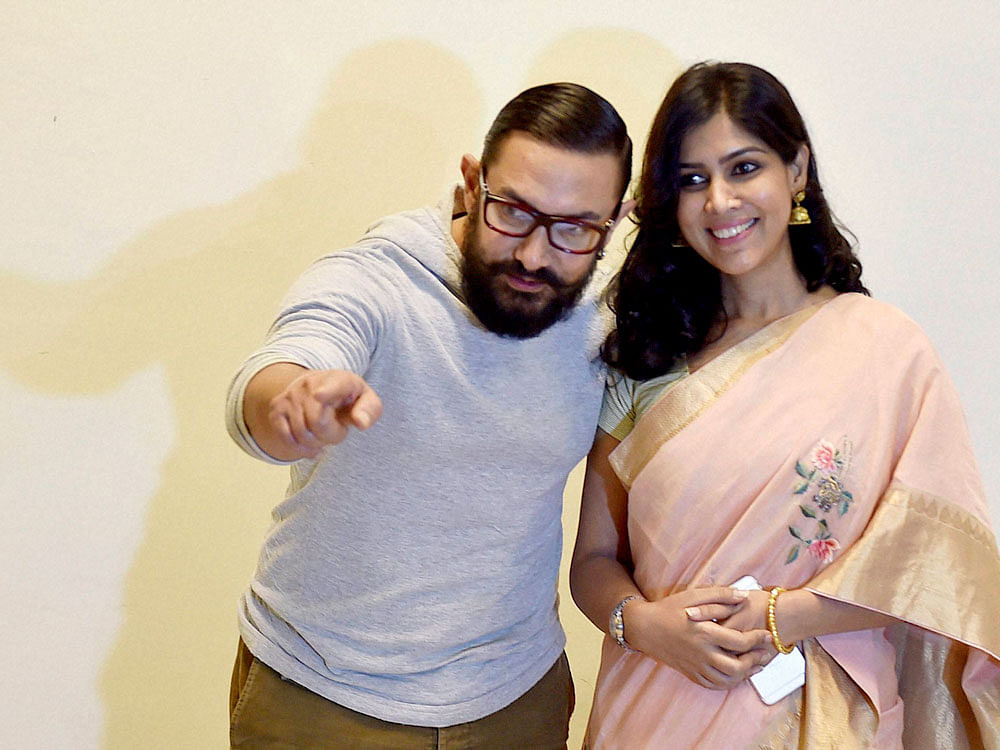 Actors Aamir Khan and Sakshi Tanwar pose for a photo during the screening of the film 'Dangal' in New Delhi on Tuesday. PTI Photo