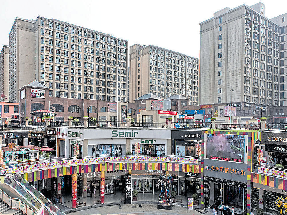 FACILITIES&#8200;GALORE: Dormitories for Foxxconn factory workers behind an open-air mall in Zhengzhou, China. nyt