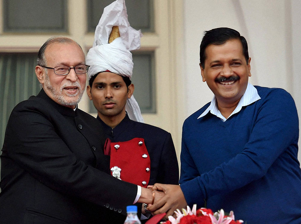 Delhi Chief Minister Arvind Kejriwal greets Anil Baijal after he was sworn in as the New Lieutenant Governor at Raj Niwas in New Delhi on Saturday.PTI Photo