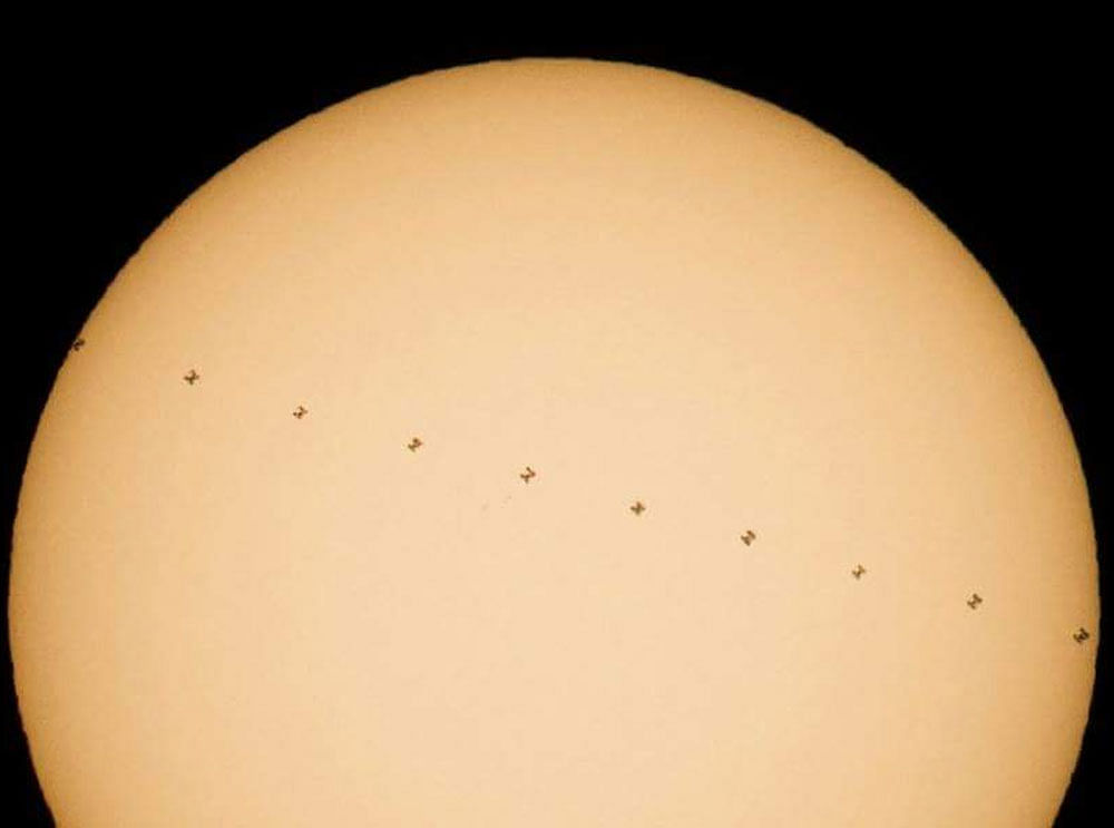 NASA photographer Joel Kowsky was able to capture several images of the ISS as it crossed the face of the sun on Dec. 17. He then combined the photos to make a composite view of the event.  Courtesy: Joel Kowsky/NASA via www.techtimes.com