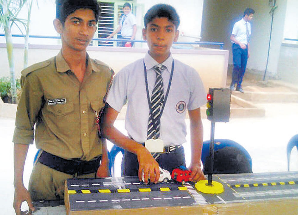 Ankur Suresh (right) displays the model.