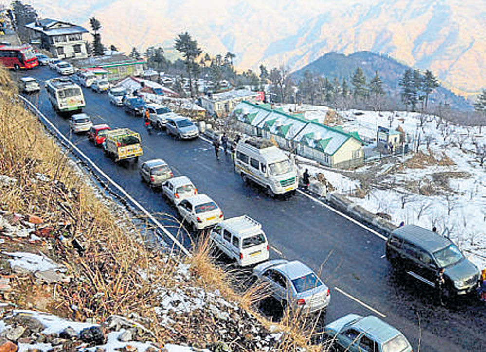 Vehicles stuck in a traffic jam after snowfall in Kufri near Shimla on Monday. PTI