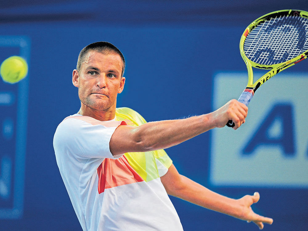Mikhail Youzhny of Russia returns during his win over Renzo Olivo. AFP