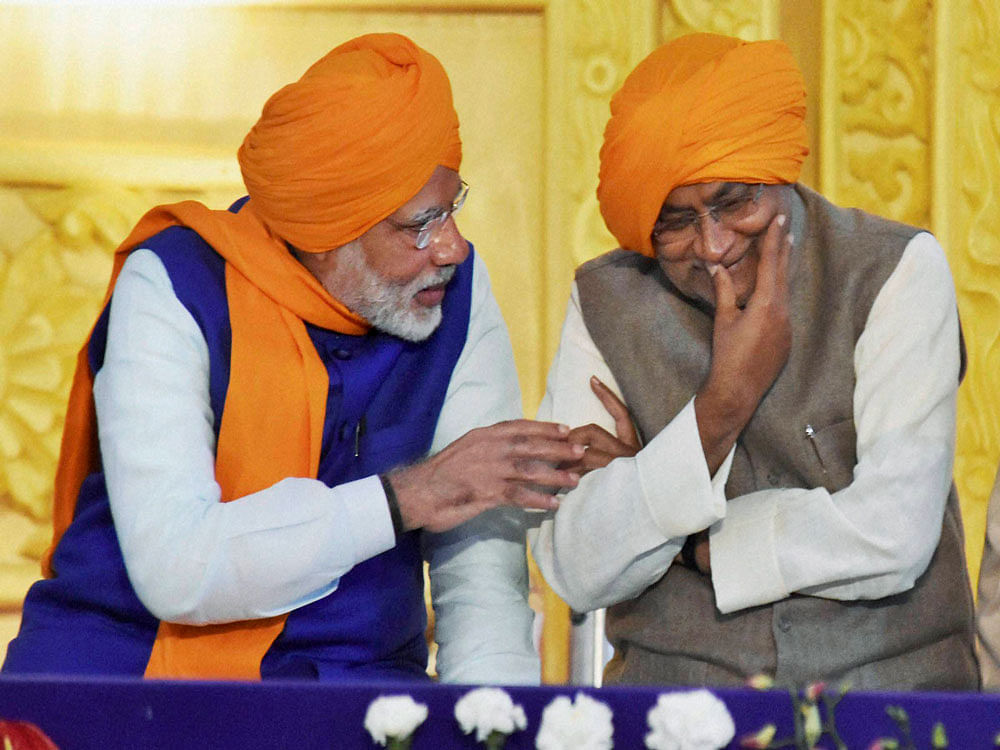 Prime Minister Narendra Modi and Bihar Chief Minister Nitish Kumar share a light moment as they participate in the 350th birth anniversary celebrations of Guru Gobind Singh at Gandhi Maidan in Patna on Thursday. PTI Photo