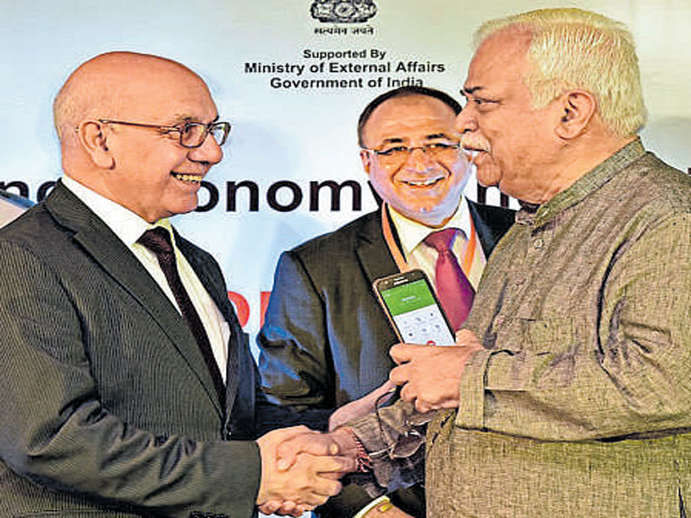 British MP Virendra Sharma greets R V Deshpande at  the event in Bengaluru  on Friday. DH Photo