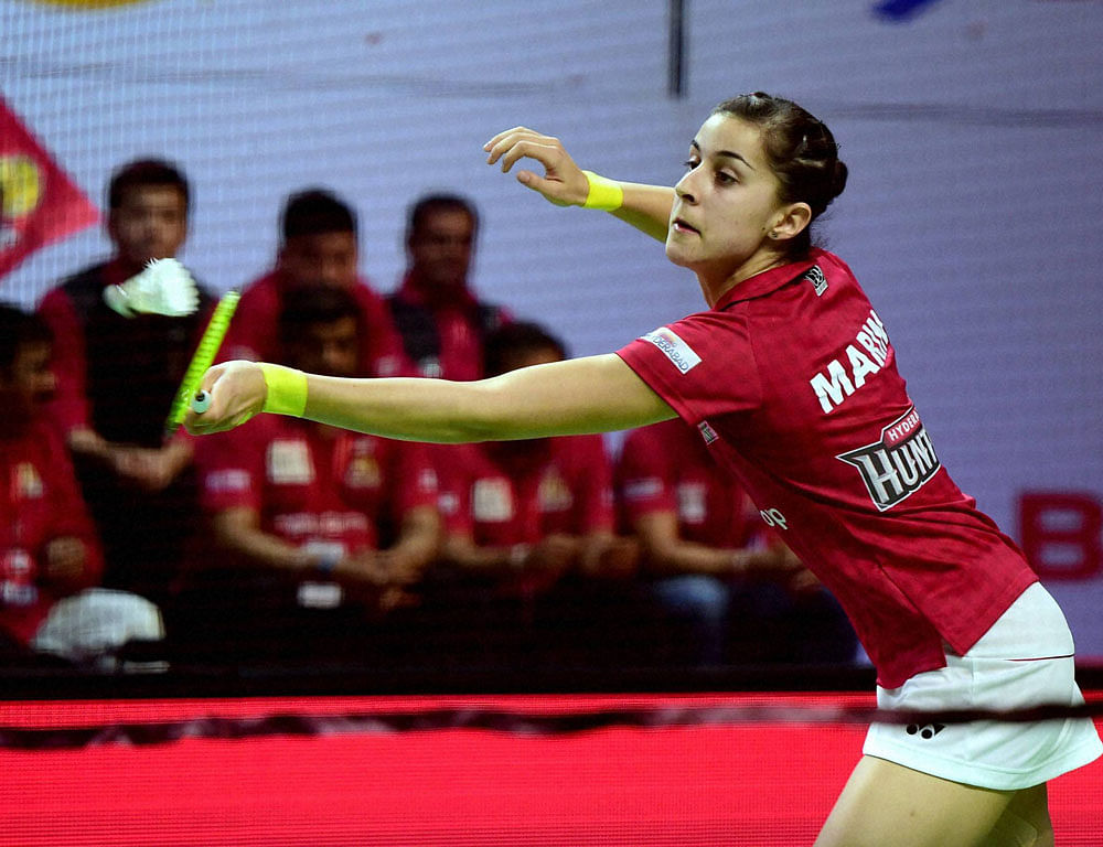 Carolin Marin of Hyderabad Hunters plays against Bengaluru Blasters mixed double team Sikky Reddy and Sung Hyun Ko during the Premier Badminton league match at Koramangla Indoor stadium in Bengaluru on Saturday. Bengaluru Blasters wins the mixed double match . PTI Photo