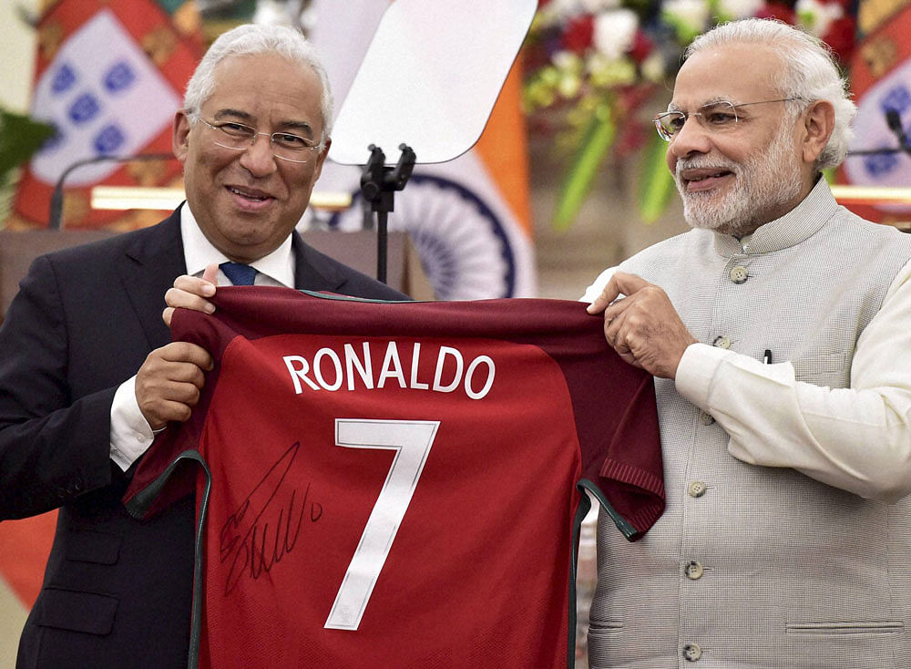 Portugal Prime Minister Antonio Costa presents a  jersey signed by Ronaldo to his Indian counterpart  Narendra Modi in New  Delhi on Saturday. PTI