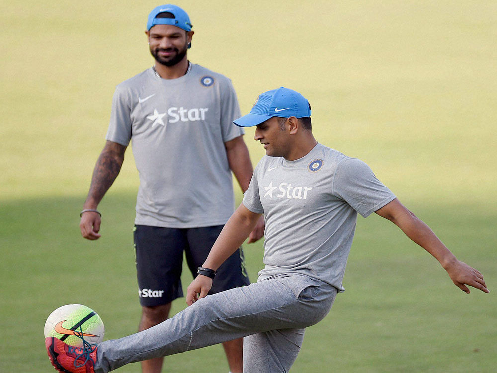 Indian cricketer MS Dhoni and Shikhar Dhawan during a practice session in Mumbai on Monday. PTI Photo