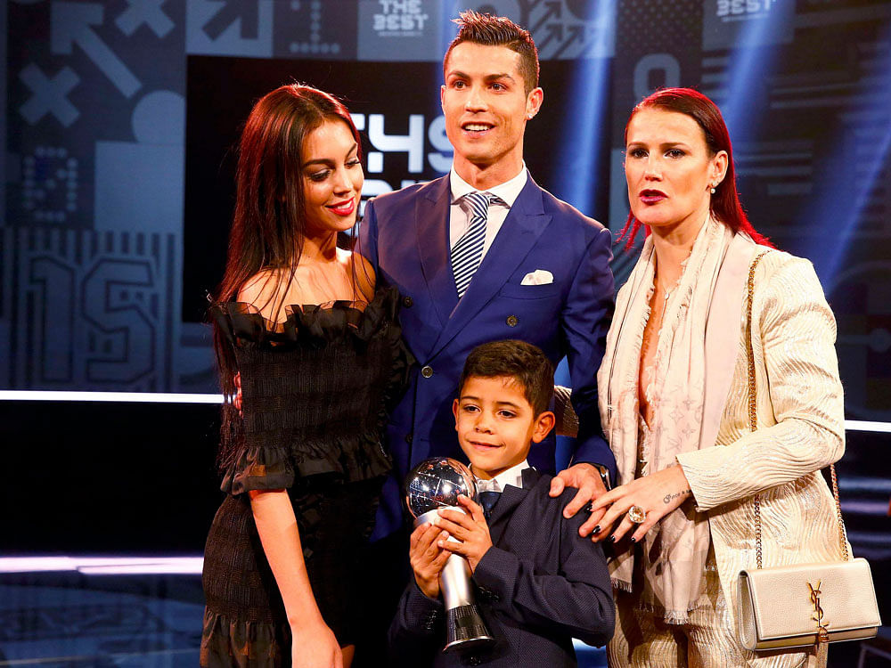 Cristiano Ronaldo poses with Georgina Rodriguez, his son Cristiano Ronaldo Jr and his sister Katia after winning with the award. REUTERS