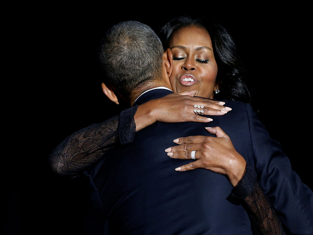 U.S. President Barack Obama embraces his wife Michelle Obama after his farewell address in Chicago, Illinois, U.S. January 10, 2017. REUTERS