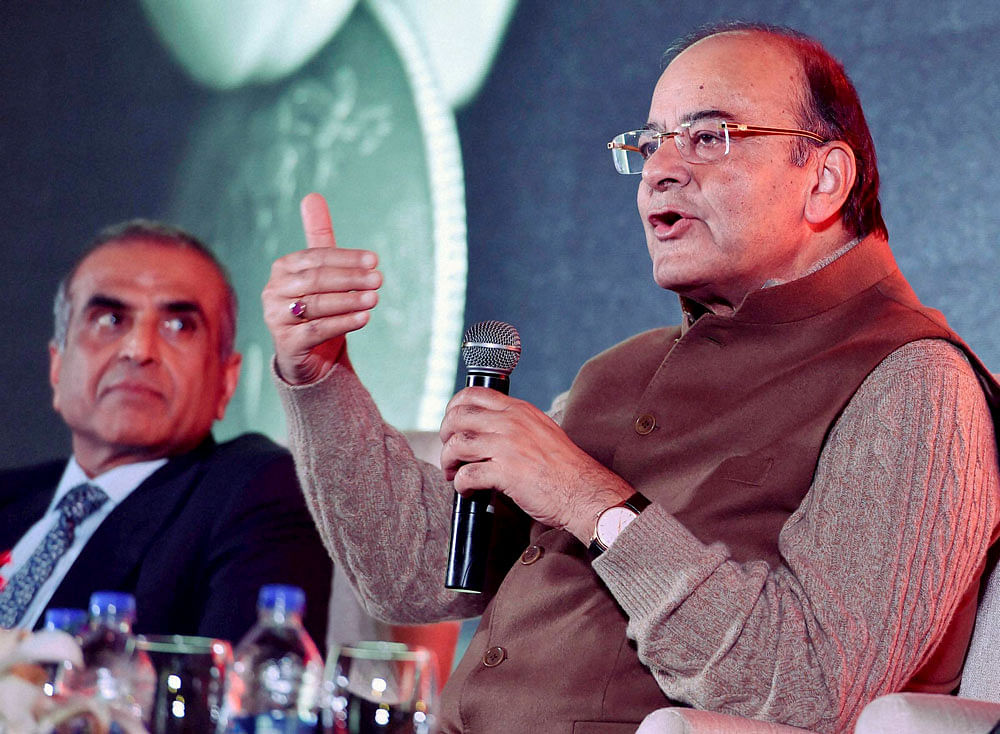 Union Finance minister Arun Jaitley speaks as Bharti Enterprises Chairman Sunil Bharti Mittal looks on during the launch of Airtel Payments Bank in New Delhi on Thursday. PTI Photo