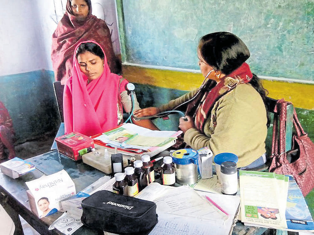 A health worker with villagers in Fakirpuri village in Uttar Pradesh.