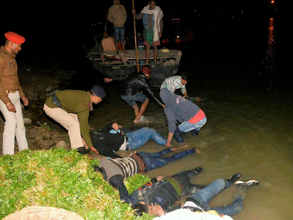 SDRF team rescue a dead bodies of passengers of a boat which capsized in Ganga river in Patna on Saturday. PTI Photo