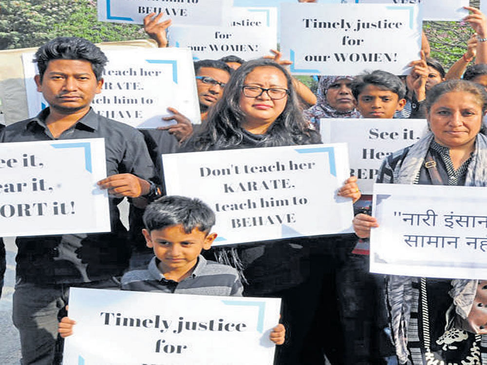 People stage a protest on Saturday against New Year's Eve molestation. dh photo
