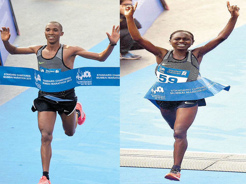 Thrilled Alphonce Simbu (left) and Bornes Kitur after clinching the men's and women's titles respectively. AFP/PTI