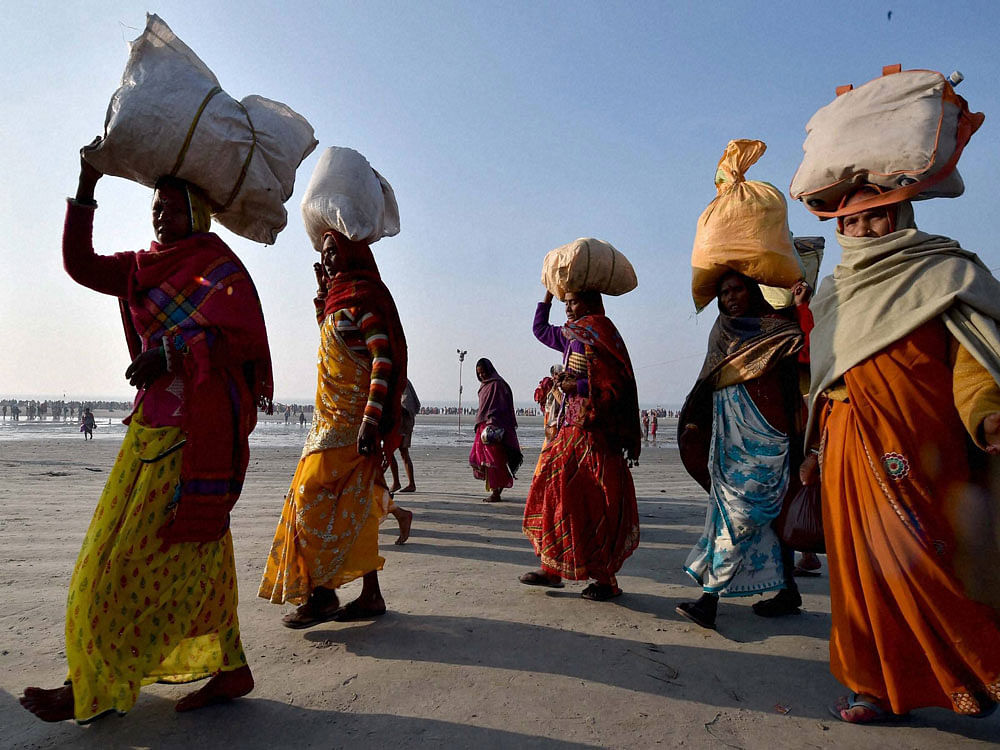 Pilgrims returning home after the end of the Gangasagar Mela, in Sagar Island near Kolkata. PTI Photo