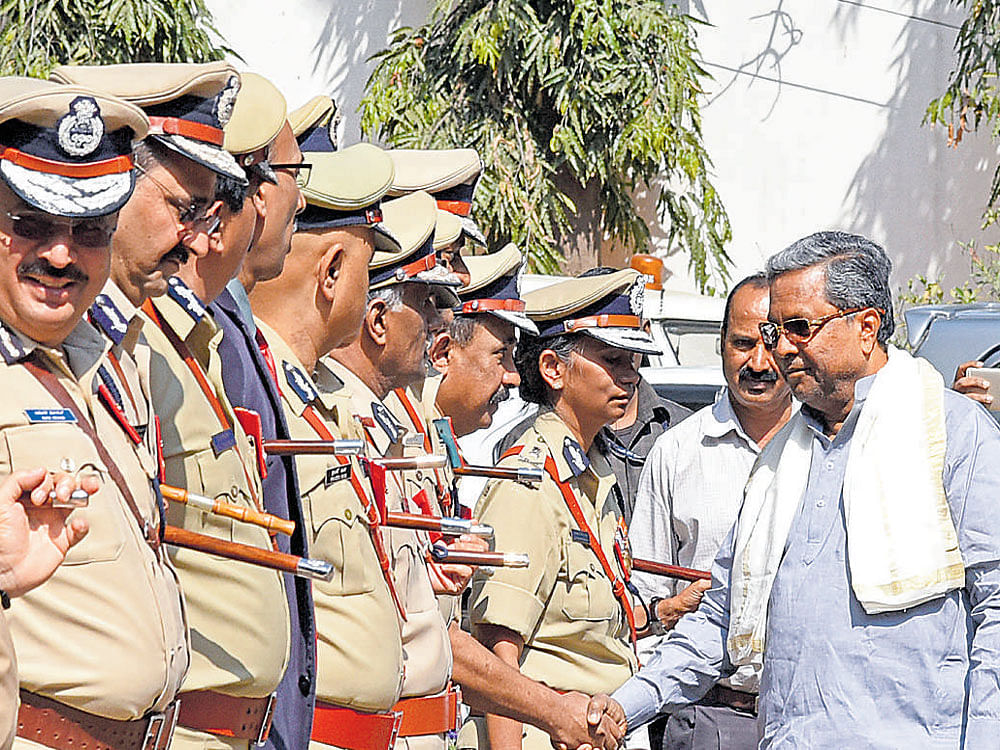 Chief Minister Siddaramaiah greets police officers before the senior police officers' annual conference at the state police headquarters in Bengaluru on Monday. DH photo