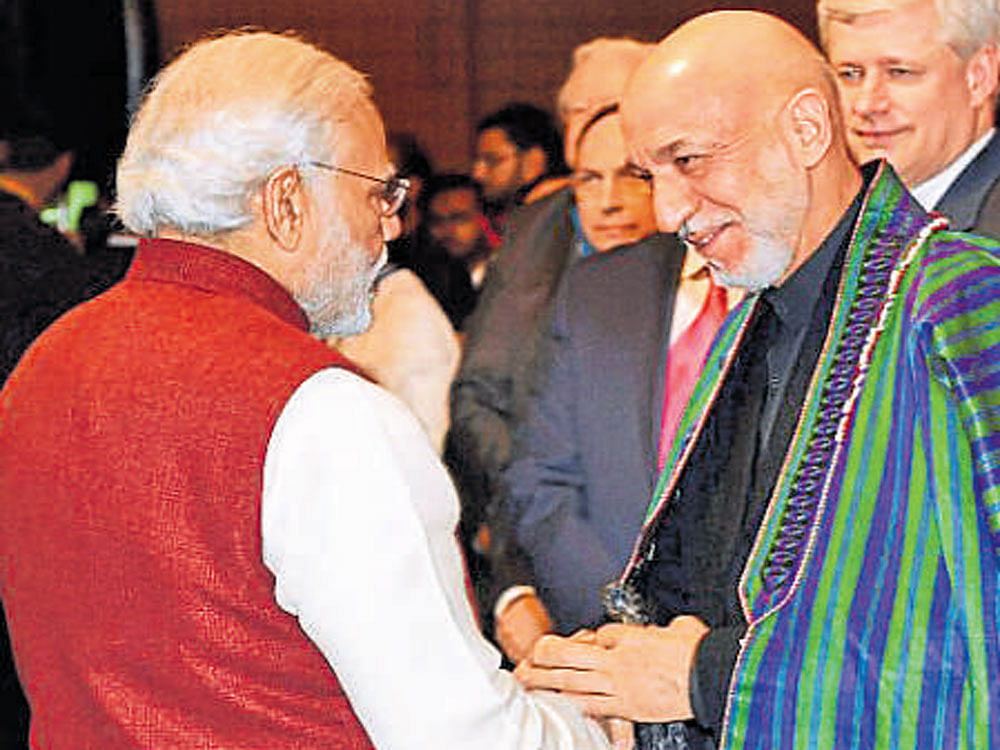 Prime Minister Narendra Modi with former Afghan president Hamid Karzai in New Delhi on Tuesday. PTI
