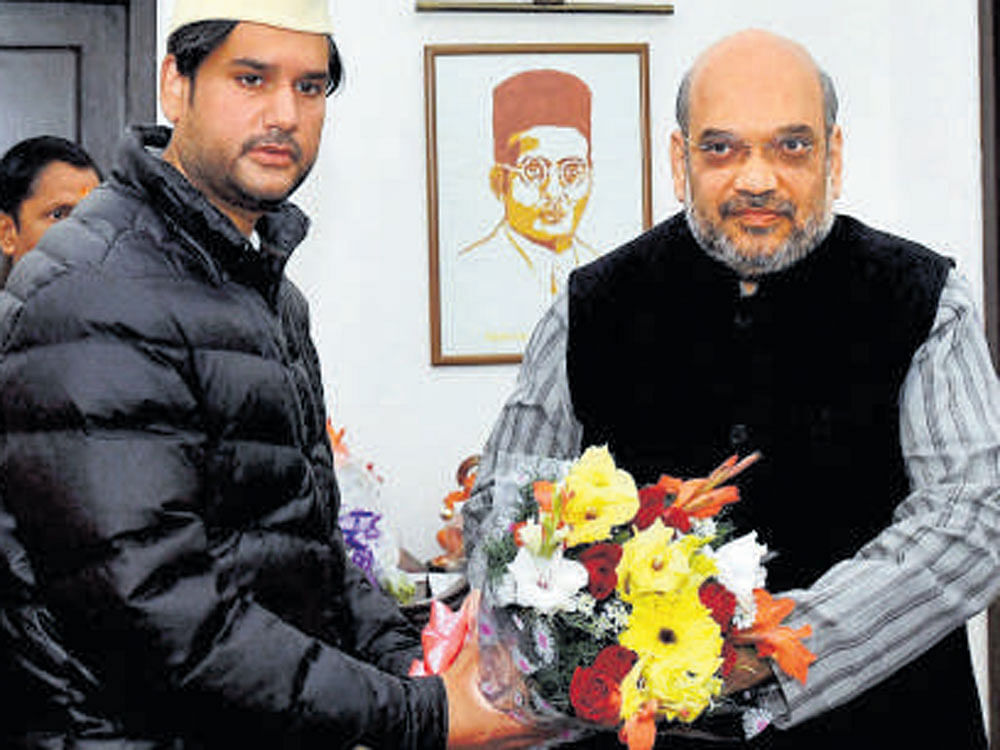 BJP president Amit Shah greets Rohit Shekhar, son of N D Tiwari, in New Delhi on Wednesday. PTI