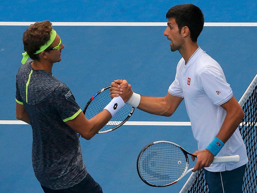 Australian Open- Uzbekistan's Denis Istomin shakes hands after winning his Men's singles second round match against Serbia's Novak Djokovic. REUTERS Photo