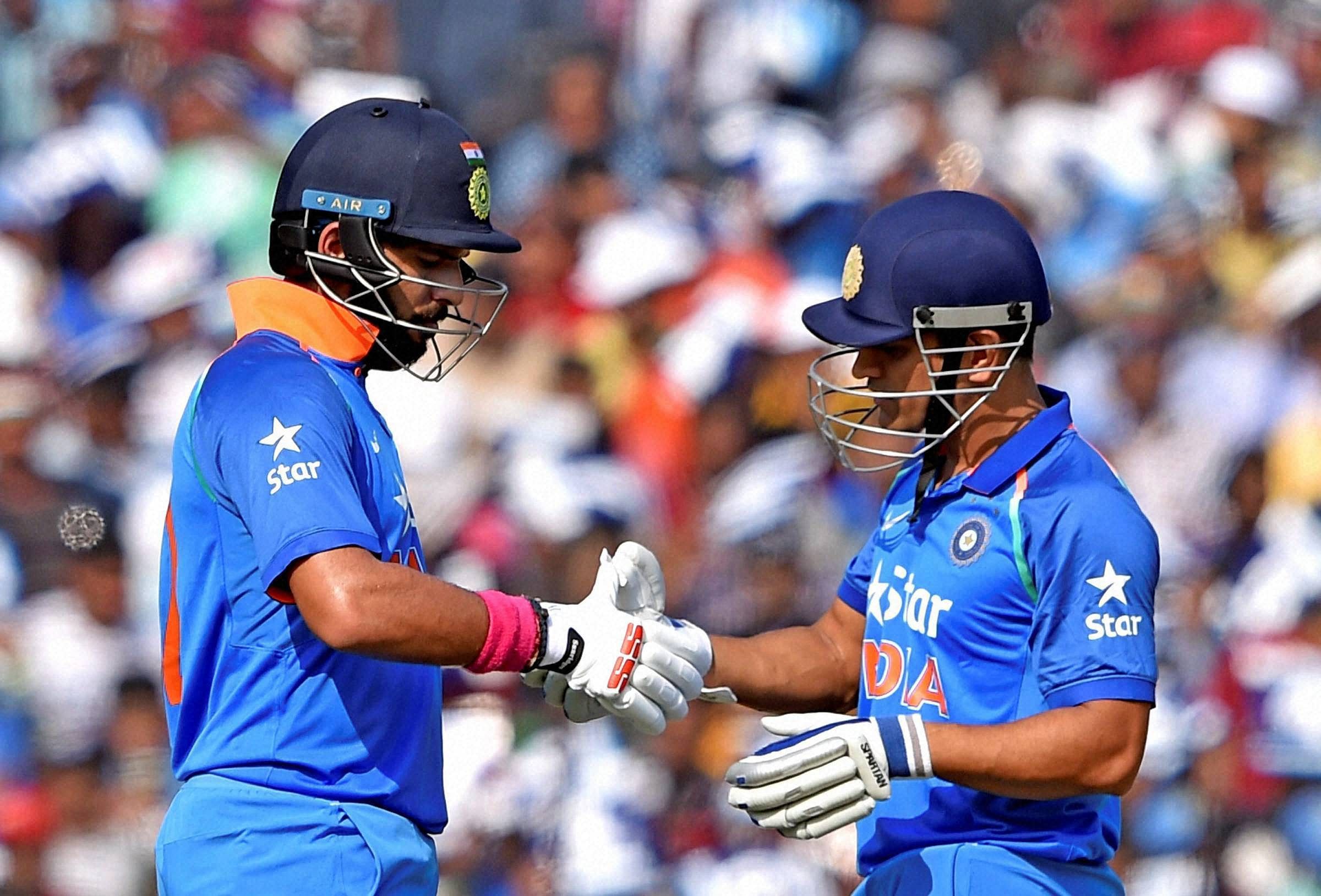 MS Dhoni and Yuvraj Singh chat during 2nd ODI Match against England at Barabati stadium in Cuttack. PTI Photo
