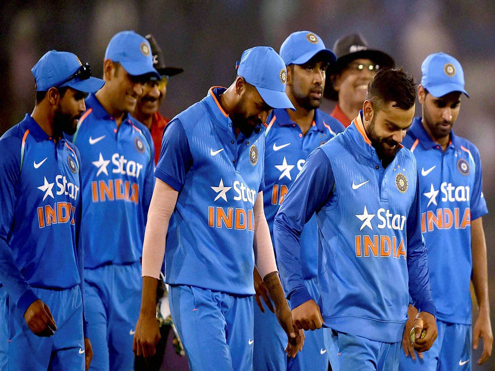 Indian Captain Virat Kohli with teammates comes out from the field after won 2nd ODI Match against England at Barabati stadium in Cuttack on Thursday. PTI Photo