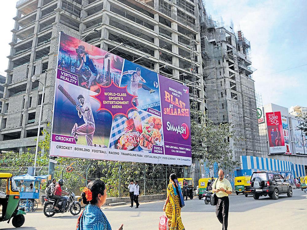 The BBMP lost Rs 2,000 crore in the last eight years because of illegal advertisement  hoardings, says a report by then assistant commissioner of the BBMP, K Mathai. dh Photo