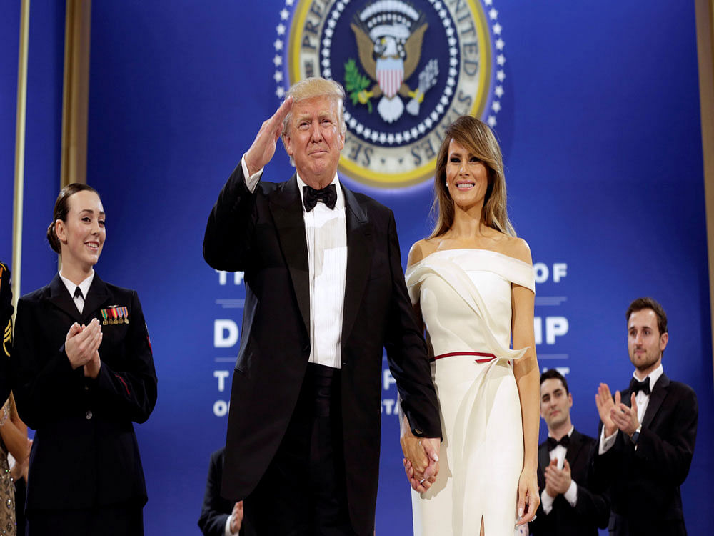 U.S. President Donald Trump salutes with his wife Melania at the Armed Services Ball in Washington, U.S., January 20, 2017. REUTERS