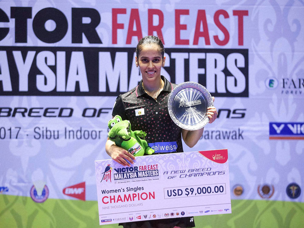 India's Saina Nehwal poses with her trophy during the awards ceremony after winning the women's singles final match during Malaysia Masters badminton tournament in Sibu, Sarawak, Malaysia Sunday. AP/PTI