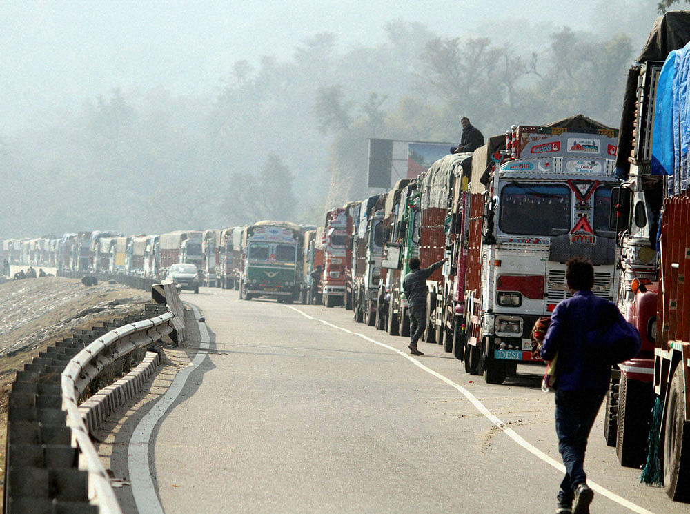 Trucks pile up while waiting for reopening of Jammu-Srinagar highway at Nagrota in Jammu on Sunday. PTI Photo