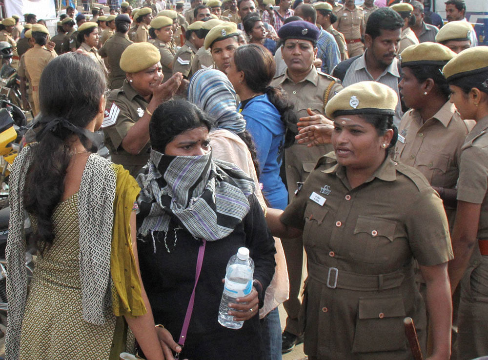 Police detain students who were holding a protest demanding a permanent solution for holding the Jallikattu, in Coimbatore on Monday. PTI Photo