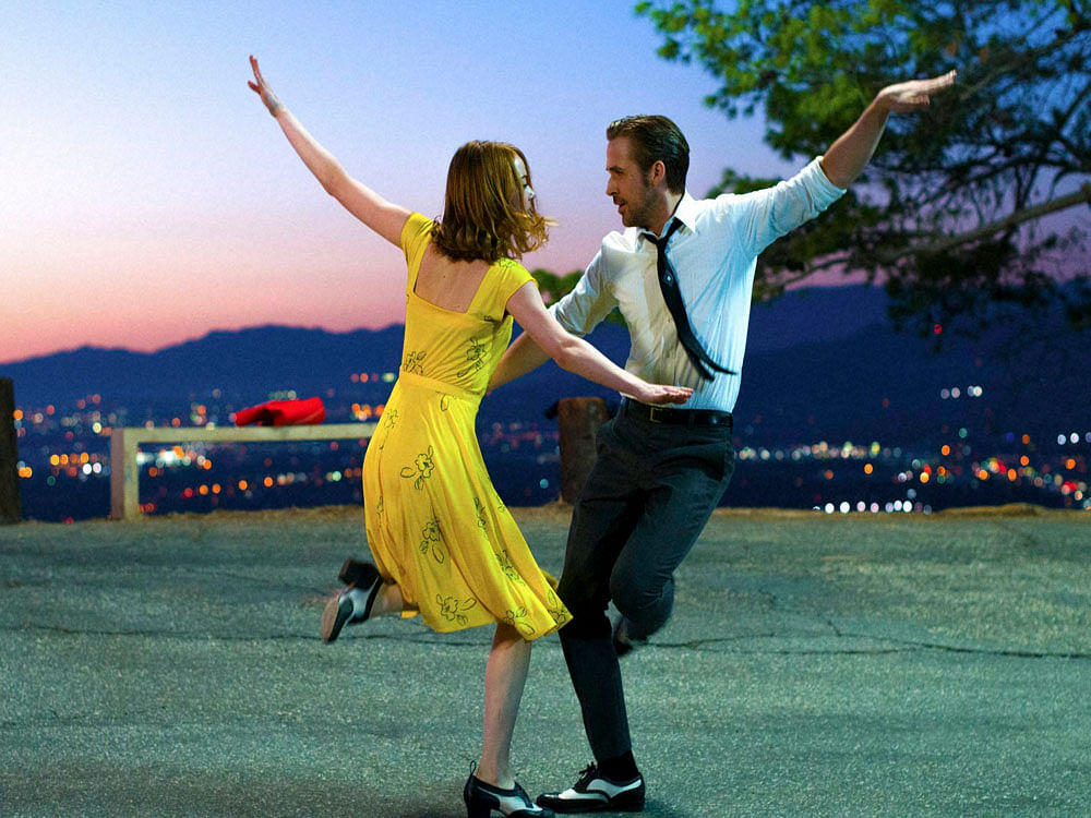 This image released by Lionsgate shows Ryan Gosling, right, and Emma Stone in a scene from, 'La La Land.' AP/PTI