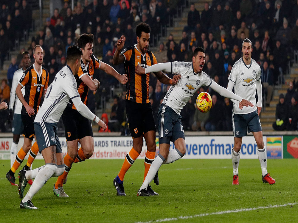 Hull City's Tom Huddlestone in action with Manchester United's Chris Smalling. Reuters photo