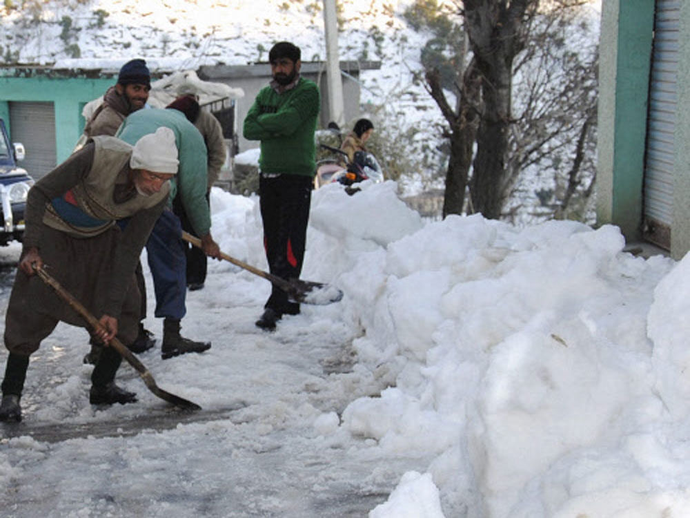 Border Roads Organisation( BRO) personnel clearing snow from the Mughal Road after heavy snowfall in Poonch district on Thrusday. PTI Photo
