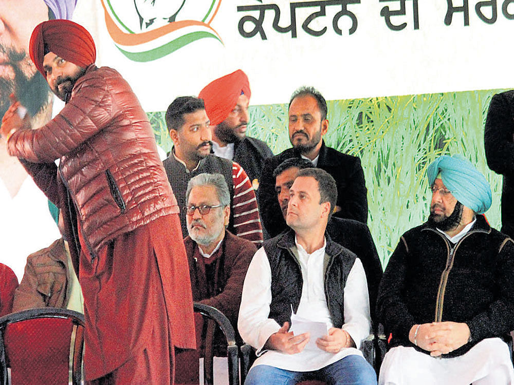 Congress vice president Rahul Gandhi, Punjab chief ministerial candidate Capt Amarinder Singh and Navjot Singh Sidhu at a rally in Jalalabad Fazilka district on Saturday. PTI