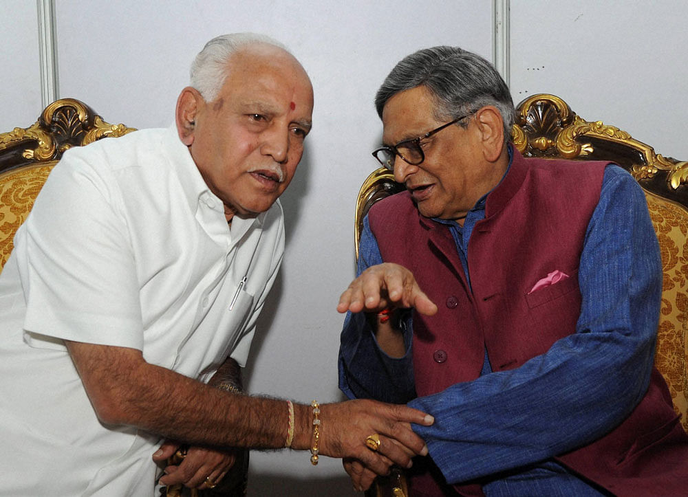 Former Chief Minister of Karnataka S M Krishna with BJP MP BS Yeddyurappa at releasing the book of Union Minister DV Sadananda Gowda at Palace Grounds, in Bengaluru on Saturday. PTI Photo